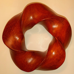 Padauk wood (3,5) torus knot, image 1 by Alex J. Feingold